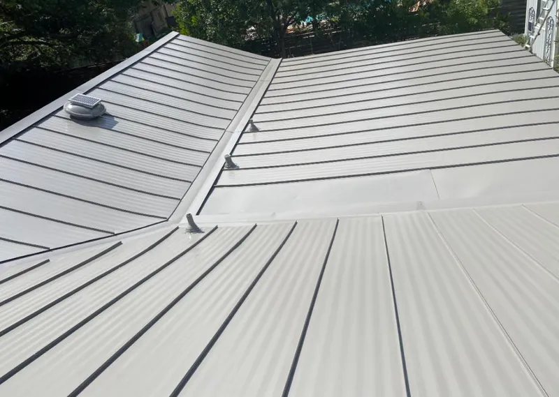 Solar attic fan installed on a metal roof for Roof Ventilation in East Point